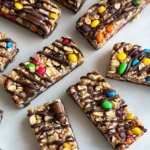 Homemade no-bake granola bars with chocolate drizzle and colorful candy