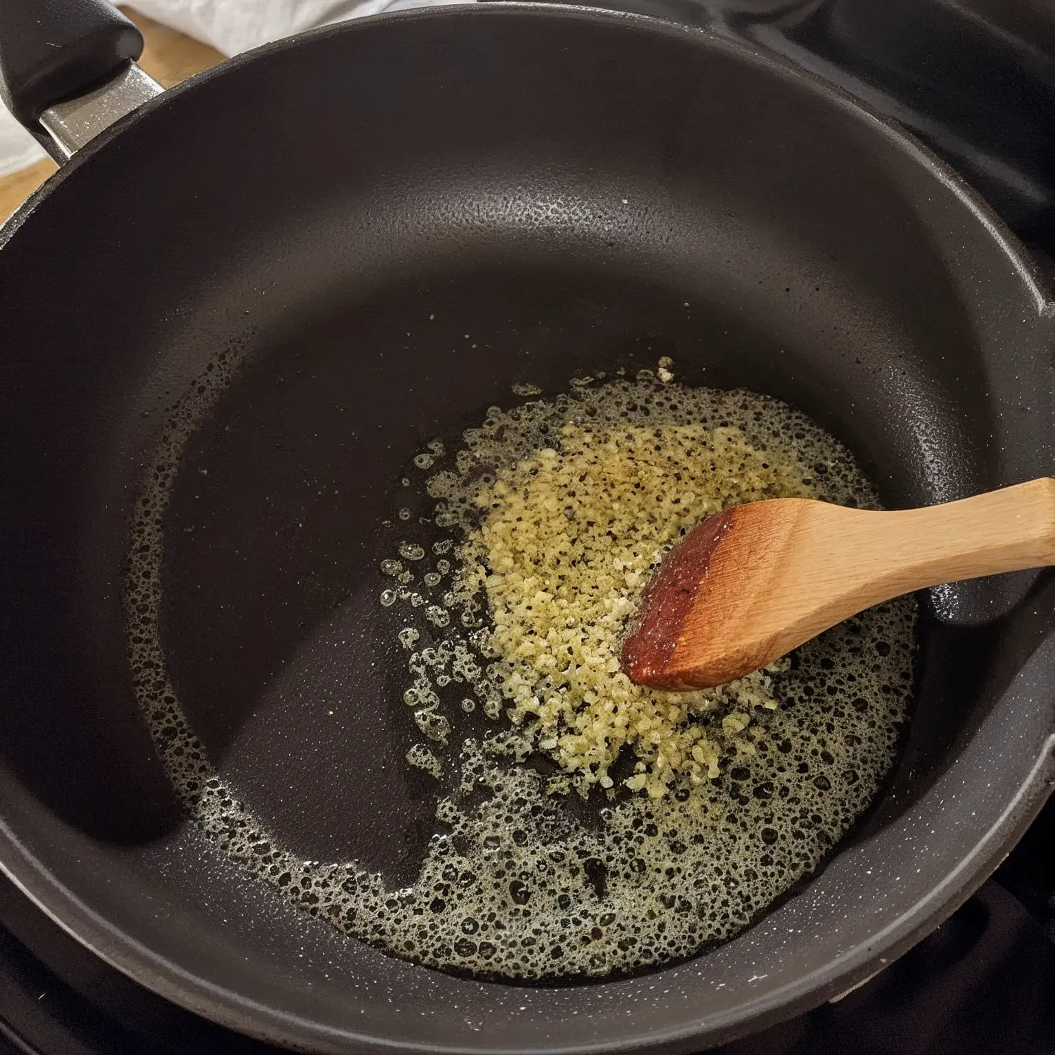 Saucepan with melted butter Garlic butter sauce cooking in a pan for crockpot chicken and potatoes